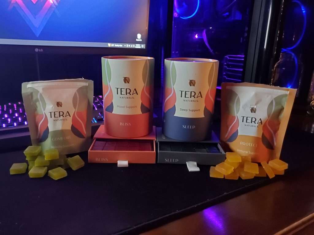 Tera Naturals four different gummy products with blue and purple computer and keyboard in the background
